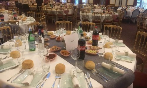 Grande salle de réception préparée par Metsouyane Traiteur casher, avec tables rondes dressées, pains individuels, boissons et entrées variées pour mariage, bar-mitsvah ou événement sur le Bassin d’Arcachon et Bordeaux.